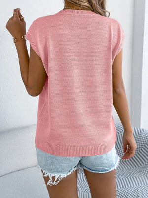 Blush pink cable knit sweater vest with cap sleeves and a crew neck.