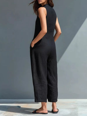 Black sleeveless button-down romper with pockets and wide legs.