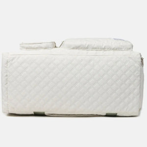 White quilted duffel bag with olive accents and zippered pockets.