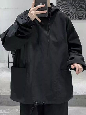 Black oversized drawstring hoodie with large front pockets and cinched cuffs.