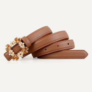 Caramel leather belt with ornate rhinestone-embellished buckle and gold accents.