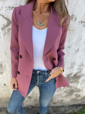 Dusty Pink double-breasted blazer with sculpted lapels and black buttons, styled with jeans.