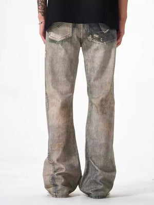 Men's loose-fit jeans in grey distressed cotton with heavy fading and rips.