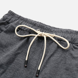 Relaxed culotte lounge shorts in charcoal grey with a drawstring waist and ribbed cuffs.