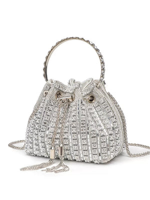 Silver rhinestone embellished mini bucket crossbody bag with chain strap and tassels.