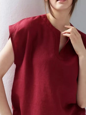 Red cap sleeve shirt with notched neckline, relaxed fit.