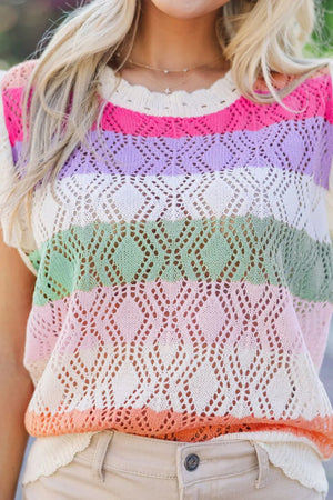 Crochet blouse with rainbow stripes, open knit diamond pattern, and flutter sleeves.
