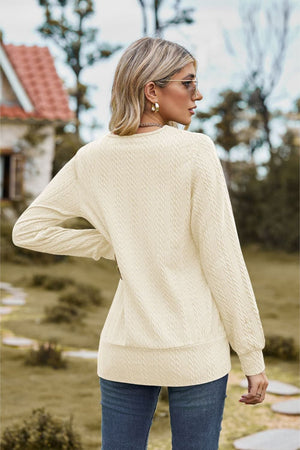 Ivory textured knit sweater with long sleeves and a square neckline.