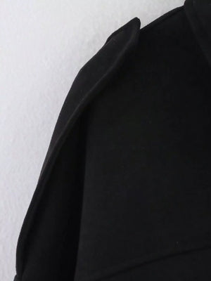 Black oversized zip-up jacket with a sharp collar detail.