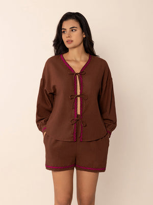 Brown linen tie-front pajama set with scallop trim and bow details.