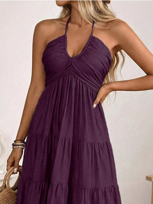 Plum purple smocked halter neck midi dress with tiered skirt.