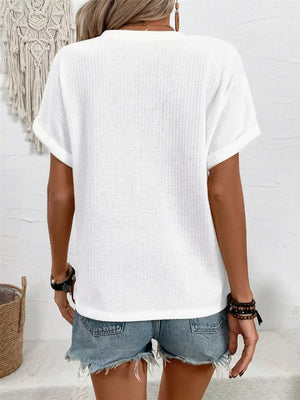 White waffle knit V-neck t-shirt with cuffed short sleeves.