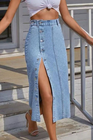 Button-front denim midi skirt in light wash with a high slit and button detailing.