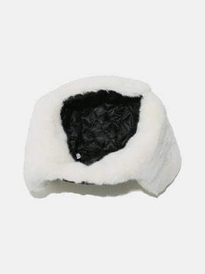 Shearling aviator trapper hat in ivory with a quilted black lining.