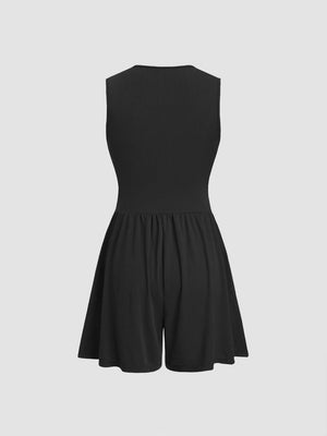 Black ribbed maternity romper with cinched waist and a-line shorts.