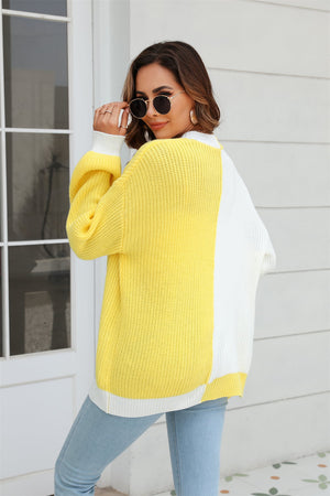 Colorblock acrylic knit cardigan in yellow and white with contrast trim and white cuffs.