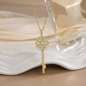 Gold-plated key pendant necklace with clear crystals and delicate chain.