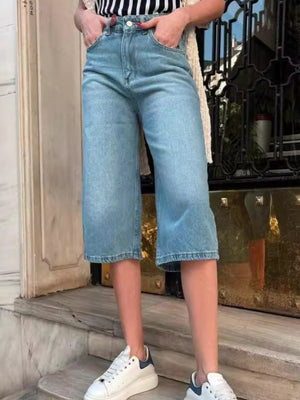 Culotte-cut denim bermuda shorts in Dusty Blue with a buttoned fly and cuffed hems.