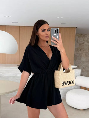 Black twist-detail V-neck romper with dolman sleeves and cinched waist