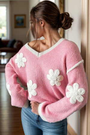 Pink acrylic v-neck sweater with white daisy appliqués and contrast trim