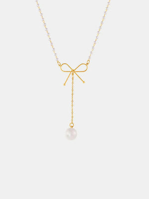 Gold lariat necklace with pearl accents and a bow detail, featuring a single pearl drop.