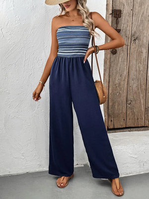 Dark blue bandeau palazzo jumpsuit with a striped bodice and wide legs.