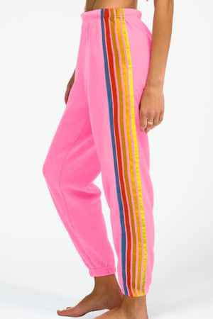 Pink track pants with rainbow stripe detail on the side