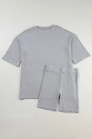 Gray ribbed knit lounge set with relaxed fit t-shirt and biker shorts.