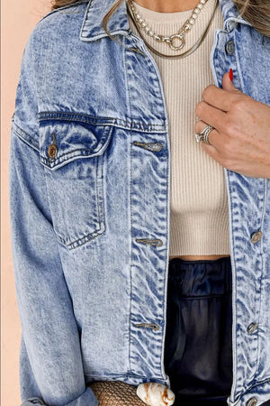 Acid wash denim jacket in medium with relaxed fit and button front.
