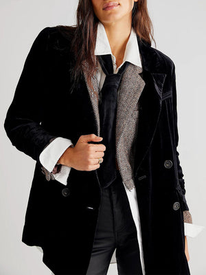 Black velvet double-breasted blazer with patch pockets and button detail.