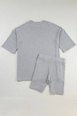 Gray ribbed knit loungewear set with relaxed fit t-shirt and bike shorts.