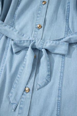 Light blue denim midi dress with button front, belt, and gold buttons.