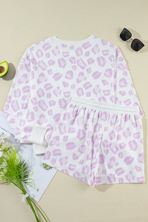 Pink leopard print loungewear set with long sleeve top and elastic waist shorts.