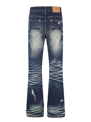 Distressed dark wash flare jeans with pocket details and button fly.