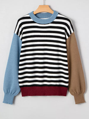 Colorblock striped knit sweater with crew neck and contrasting sleeves and hem.