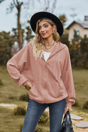 Textured cable knit zip-up hoodie in dusty pink with a relaxed fit and front pockets.