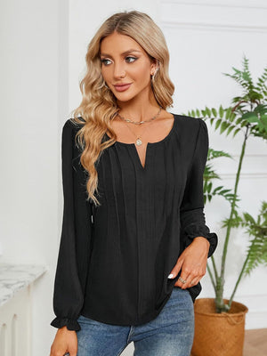 Black textured pleat-front blouse with V-neck and ruffle cuffs.