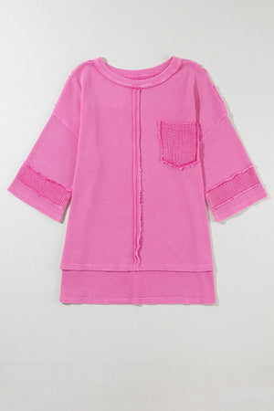 Fuchsia pink waffle knit top with raw seam details, crew neck, and chest pocket.