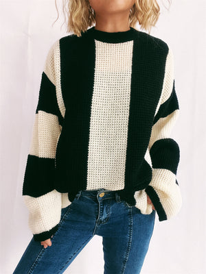Black and cream vertical stripe waffle knit sweater with crew neck and long sleeves.