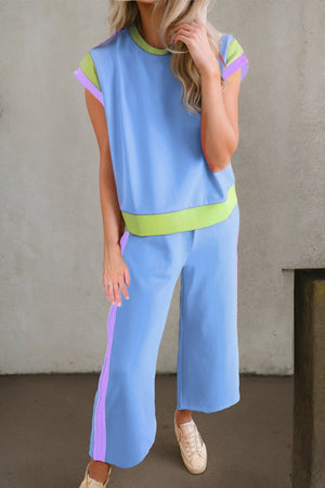 Light blue sportswear set with contrast trim on sleeves, neckline, waistband, and pants.