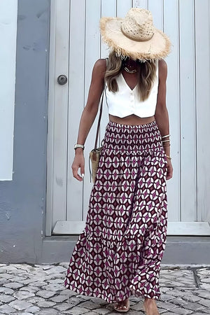 Maxi skirt with geometric print, smocked waist, and tiered hem in plum and white.