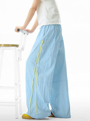 Men's pastel blue loose-fit casual sweatpants with yellow drawstring detail.