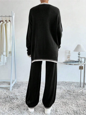 Black knit loungewear set with white striped trim and slit detail on sweater.