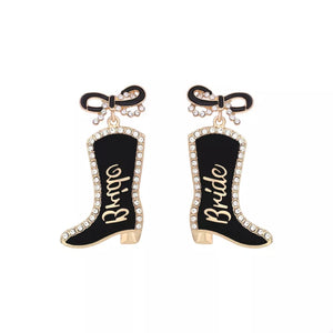 Black bridal cowboy boot dangle earrings with crystal trim and bow detail.