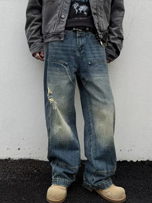 Distressed dark wash wide-leg jeans with a relaxed fit and faded details.