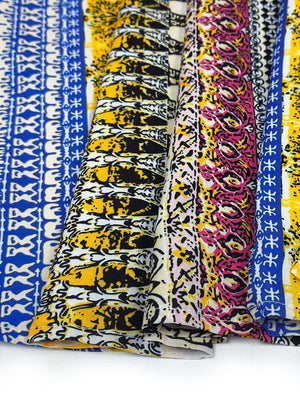 Bohemian maxi dress fabric detail in yellow, blue, and pink abstract patterns.