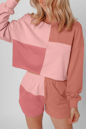 Colorblock loungewear set with cropped sweatshirt and shorts in dusty pink and light blue.