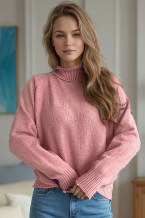 Blush pink speckled Donegal turtleneck sweater with ribbed cuffs and neckline.