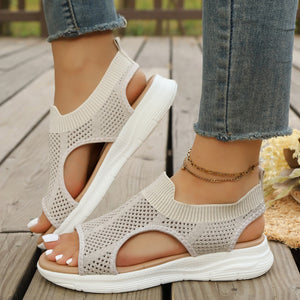 Ivory knit open-toe sandals with ankle cuff and white sole.