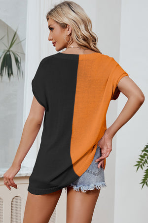 Split-tone knit tee in black and tangerine with dolman sleeves and a relaxed fit.